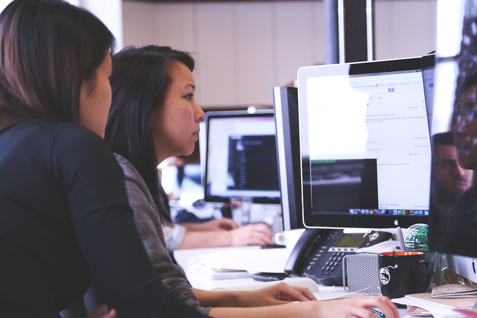 girls working on a Mac PC